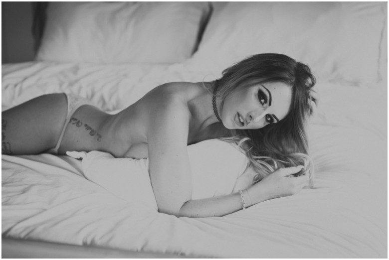 female model semi nude on a bed