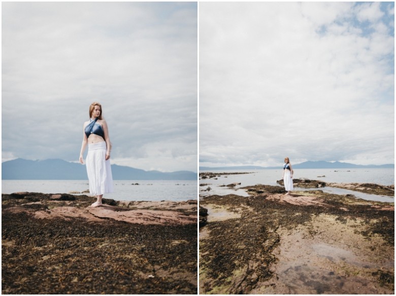 girl standing on rocks on a beach