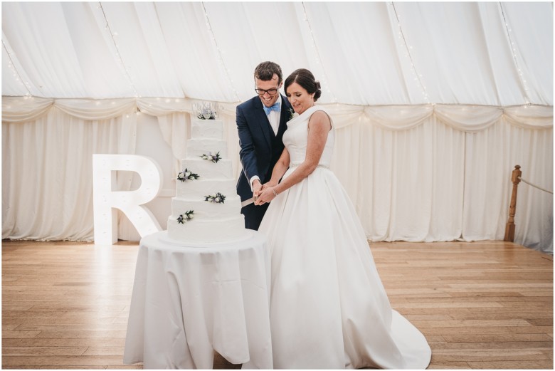 bride and groom cutting their wedding cake